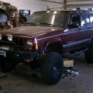 As it sat in Eric's (trailratethis) garage after he did a lot of work on it for me while I was deployed to Iraq.

Probably close to 6" of lift with 31